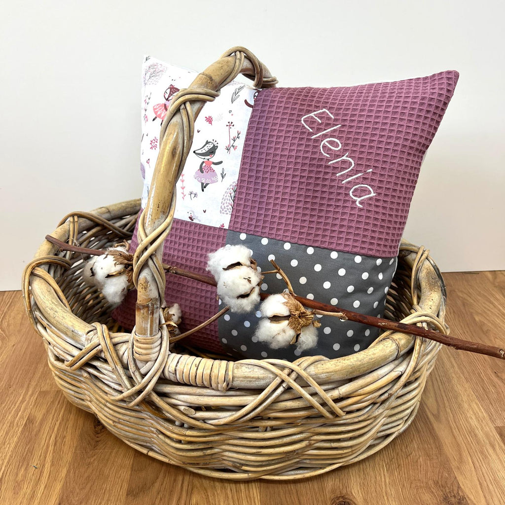 a basket filled with pillows and a pillow on top of a wooden floor