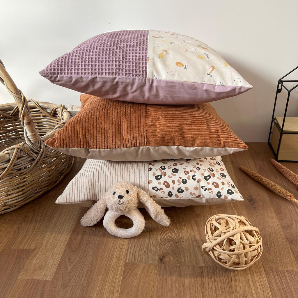 a pile of pillows sitting on top of a wooden floor